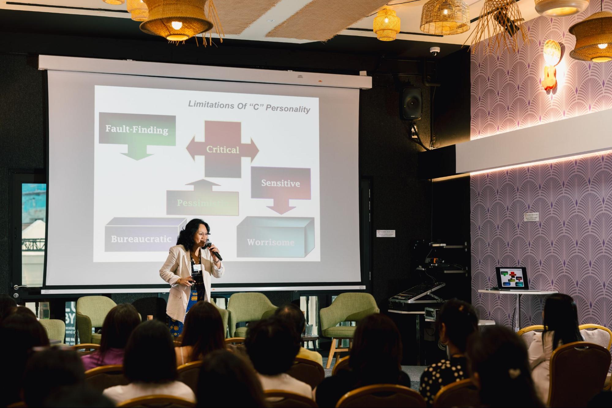 Dr. Caroline Dawson delivering a DISC training keynote on stage
